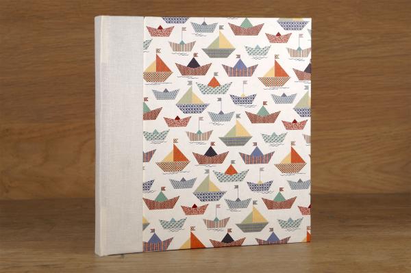 Album with white pages, paper boats, handmade